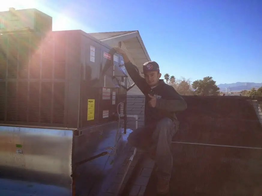 HVAC technician performing HVAC Inspection on a rooftop unit in South Jordan